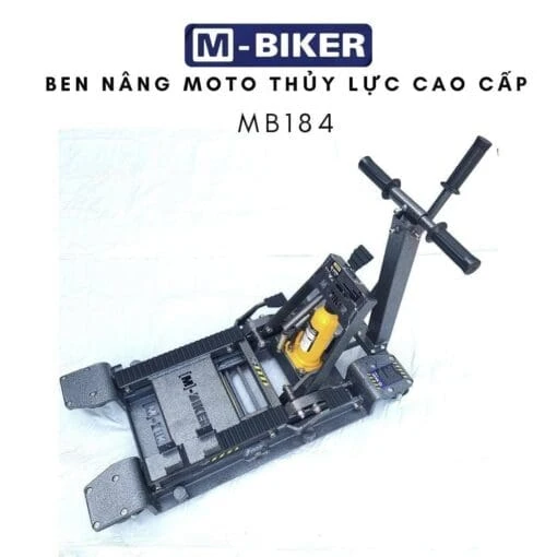 Tay người thợ đang thao tác bơm thủy lực đều tay trên cần gạt để nâng chiếc mô tô phân khối lớn lên cao